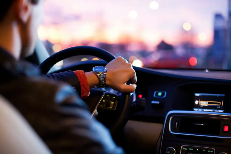 Conductor con la mano en el volante de un coche